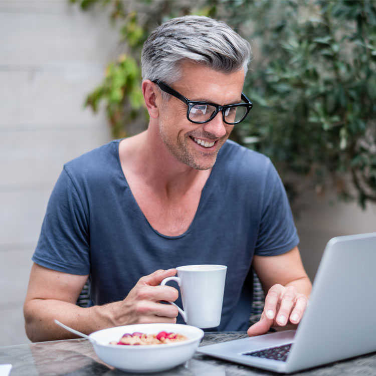 Man with glasses using laptop